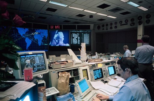 Flight Director Robert Castle uses laptop while monitoring space walk