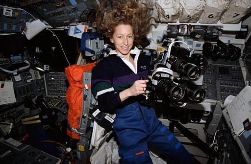 Astronaut Marsha Ivins prepares to use three Hasselblad cameras together