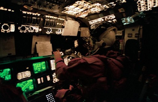 Astronaut Andrew Allen monitors Columbia's systems from pilots station