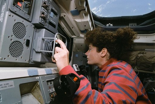 Astronaut Susan Helms on aft flight deck with RMS controls