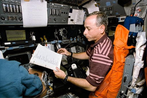 Astronaut Carl Meade mans pilots station during trajectory control exercise