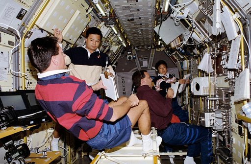 STS-65 crew works inside the IML-2 spacelab module aboard Columbia, OV-102