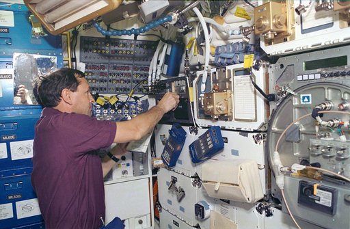 Astronaut Curtis Brown works with SAMS on Shuttle Atlantis middeck