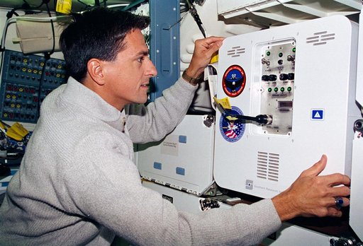 Thomas checks the condition of the MIS-B middeck locker experiment