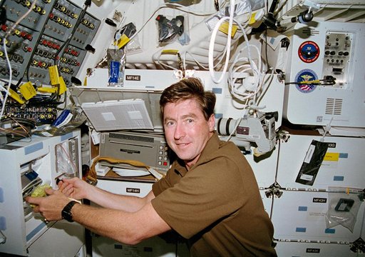 Henricks rehydrates a food packet at the shuttle orbiter repackaged galley (SORG)