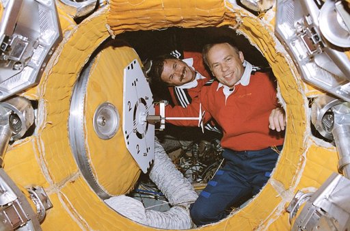 Solovyev and Budarin prepare to close hatch to docking module
