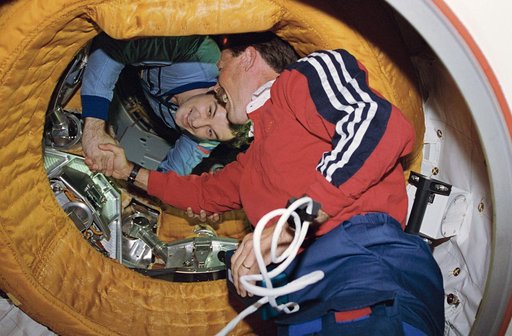 Astronaut Gibson and Comonaut Dezhurov shake hands