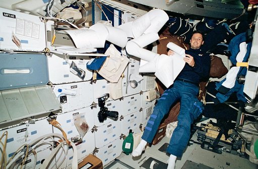 Astronaut Harbaugh on middeck with messages from TIPS