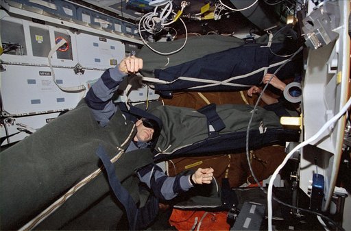 Astronaut Daniel T. Barry asleep in the middeck