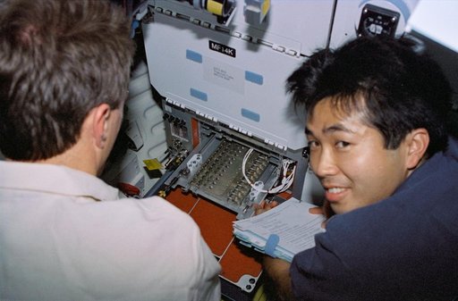 Astronauts Brent Jett and Koichi Wakata work with Protein Crystal Growth experiment