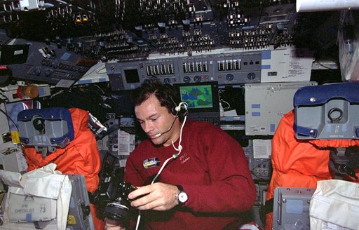 Mission Specialist Michael Lopez-Alegria changes out film in camera