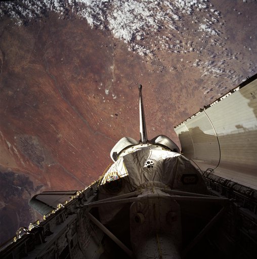 Payload bay with Spacelab backdropped by Earth