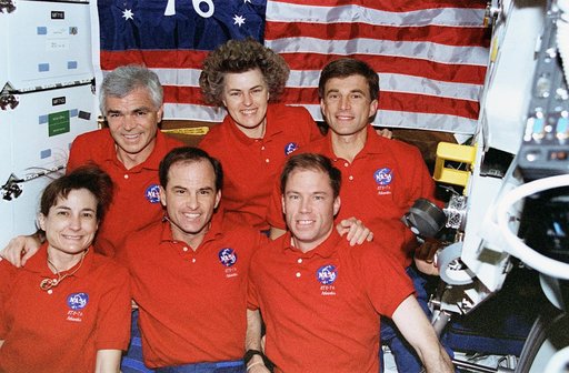 Crew portrait in middeck in front of "Spirit of 76" flag