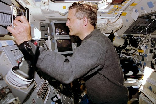 STS-77 crewmembers photographed working with RMS controls