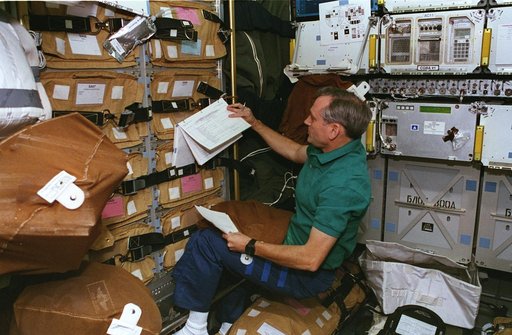 STS-79 crewmembers preparing stowage for transfer