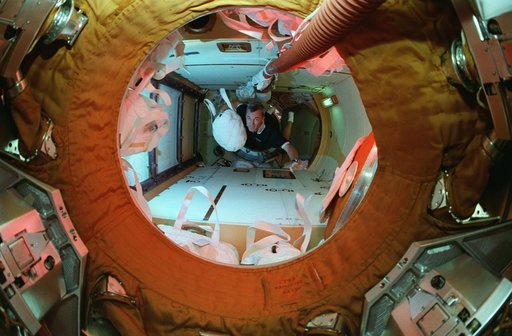 Astronaut Wilcutt with water transfer bag in docking module