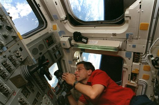 Astronaut Apt takes photos of the Earth from the aft flight deck