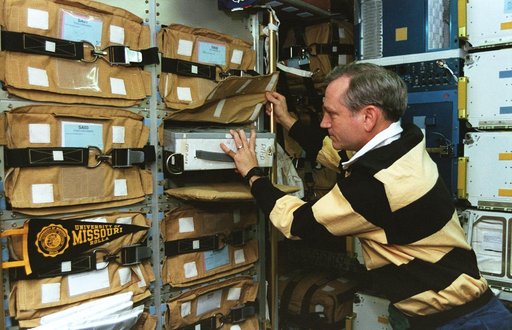Astronaut Akers in Spacehab with stowage items
