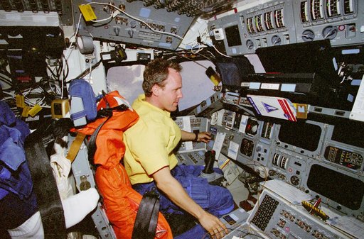 Mission Specialist Tom Jones performs stationkeeping ops in the flight deck
