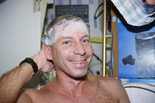 Cockrell washs hair and face