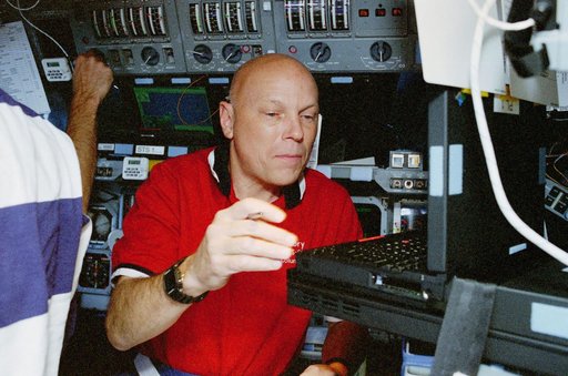 WSF, Story Musgrave monitors the condition of the satellite
