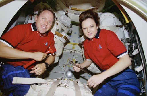 Mission Specialists Jones and Jernigan pose for photos in airlock