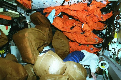 STS-81 crew on middeck preparing for re-entry