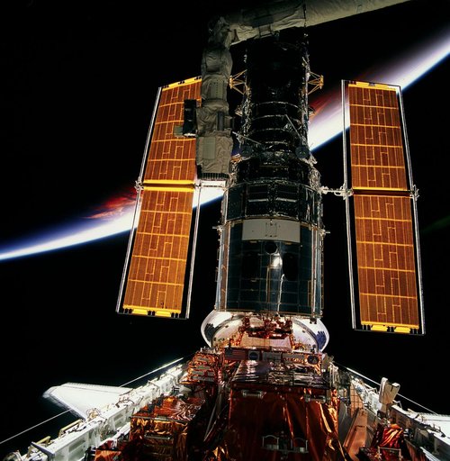 HST, full length views of telescope in payload bay after capture and berthing