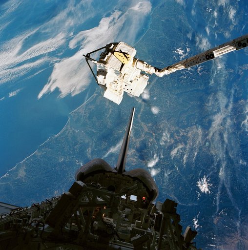 CRISTA-SPAS, held over the payload bay by the RMS after rendezvous and capture