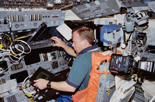Lindsey works with several laptop computers in the flight deck