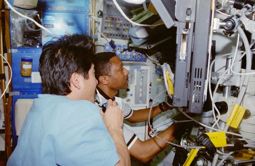 USMP-4 MGBX, Scott and Doi work with a glovebox experiment