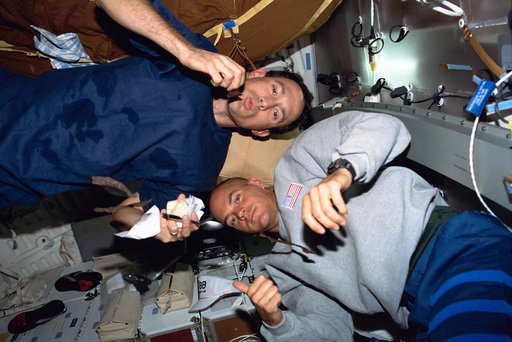 Newman and Sturckow on the middeck with beef jerky