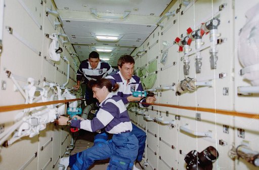 Currie and Krikalev pull launch restraint bolts in the FGB/Zarya module