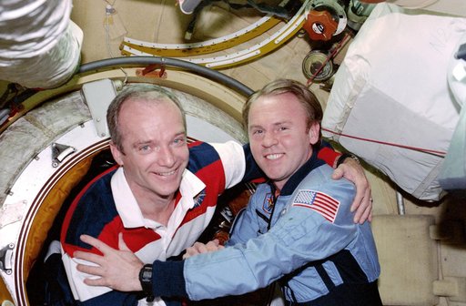 STS-91 crew is greeted at the hatch by Mir 25 crewmembers