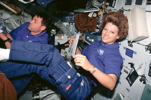 STS-93 Commander Collins and Pilot Ashby working on the middeck of Columbia