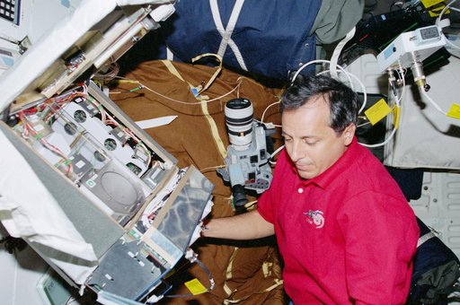 STS-93 MS Tognini works with the CGBA experiment on the middeck of Columbia