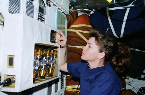STS-93 MS Coleman checks on the LFSAH experiment on the middeck of Columbia