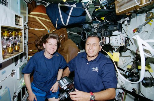 STS-93 Tognini and Coleman take photographs on the middeck of Columbia