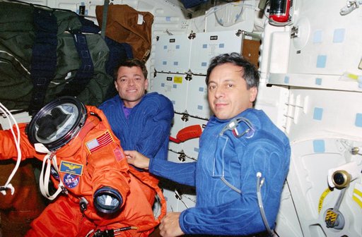 STS-93 Tognini and Ashby prepare to put on their LES on the middeck