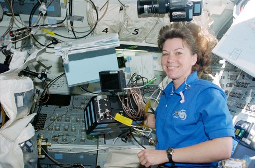 STS-93 MS Coleman sets up the HD camera on the flight deck of Columbia