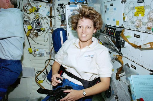 STS-93 Commander Collins uses a digital camera on the middeck of Columbia