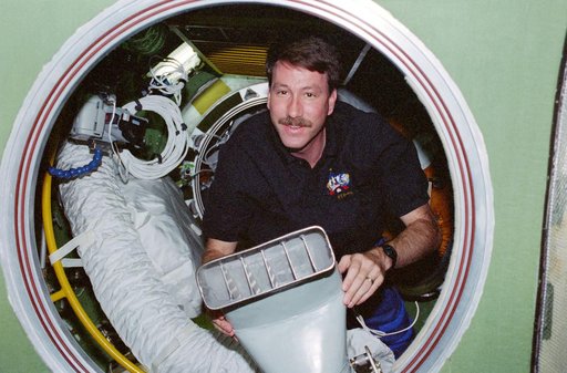 Kent Rominger holds a ventilation duct