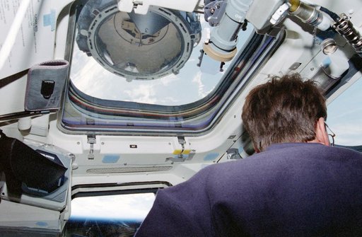 Kent Rominger at aft flight deck controls during docking