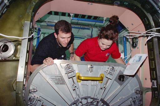 Rick Husband and Tamara Jernigan perform IFM on Node 1/Unity aft hatch