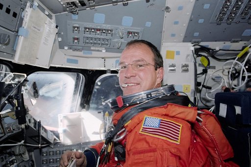 Pilot Bloomfield at the pilot's workstation during re-entry preparations