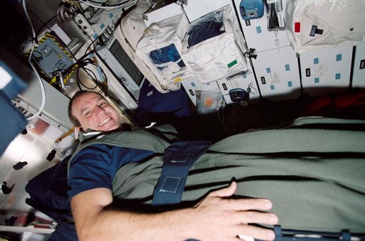 Pilot Bloomfield in a sleep restraint on the middeck during STS-97