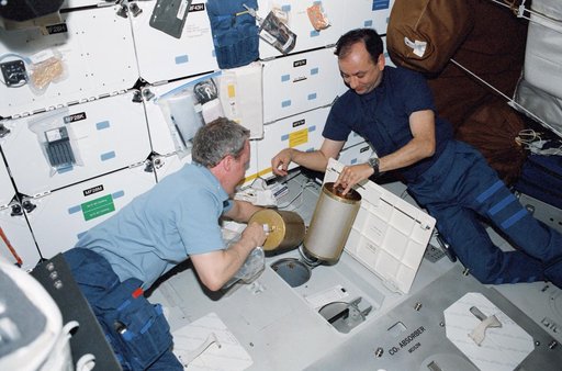 Jones and Polansky perform a LiOH Canister changeout on Atlantis' MDK