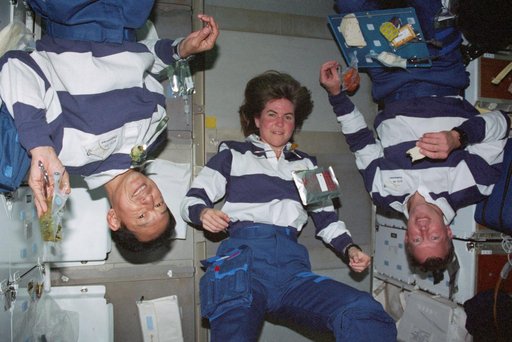 STS-99 Mohri,Voss & Gorie pose during a meal on OV-105's middeck