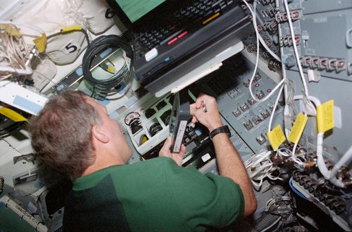 STS-99 Pilot Gorie changes a SRTM data tape on OV-105's flight deck