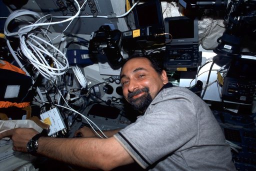 MS Guidoni at work on the flight deck of Endeavour during STS-100